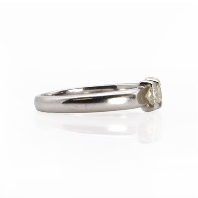 Lot 1057 - A white gold three stone diamond ring