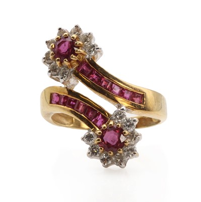 Lot 1126 - A ruby and diamond double cluster crossover ring