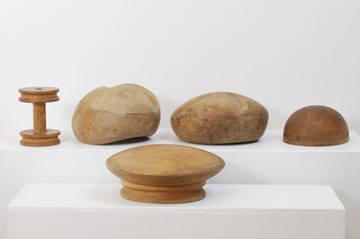 Lot 440 - A set of four fruitwood milliner's hat moulds