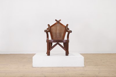 Lot 316 - A teak elbow chair by J M Edmond of Calcutta
