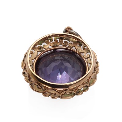 Lot 1168 - A rose gold synthetic colour change sapphire ring and pendants set
