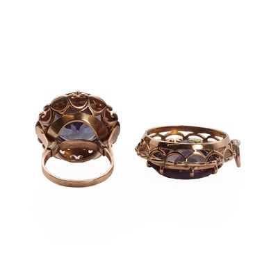 Lot 1168 - A rose gold synthetic colour change sapphire ring and pendants set