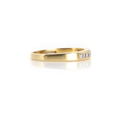 Lot 1083 - An 18ct gold diamond half eternity ring