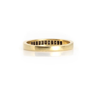 Lot 1083 - An 18ct gold diamond half eternity ring