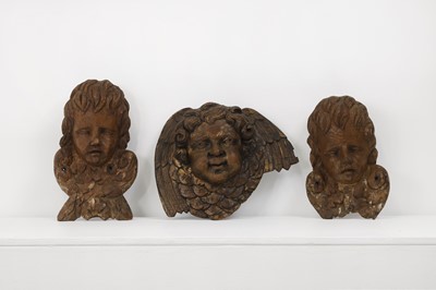 Lot 549 - Three carved wood putto masks