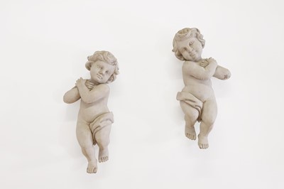 Lot 596 - A pair of carved and painted wooden putti