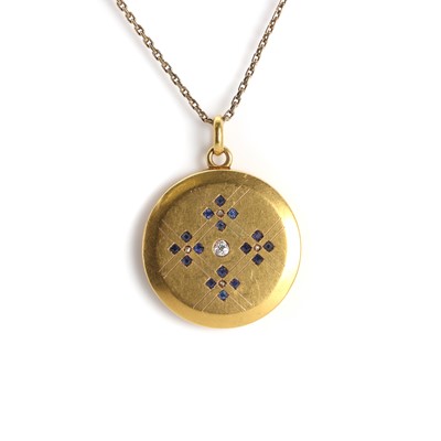 Lot 1030 - A 1920s diamond and sapphire set circular locket