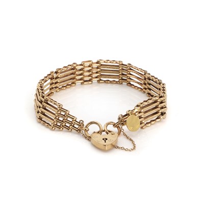 Lot 1414 - A 9ct gold gatelink bracelet with 18ct charm