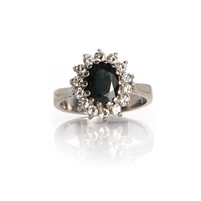 Lot 1159 - A sapphire and diamond cluster ring