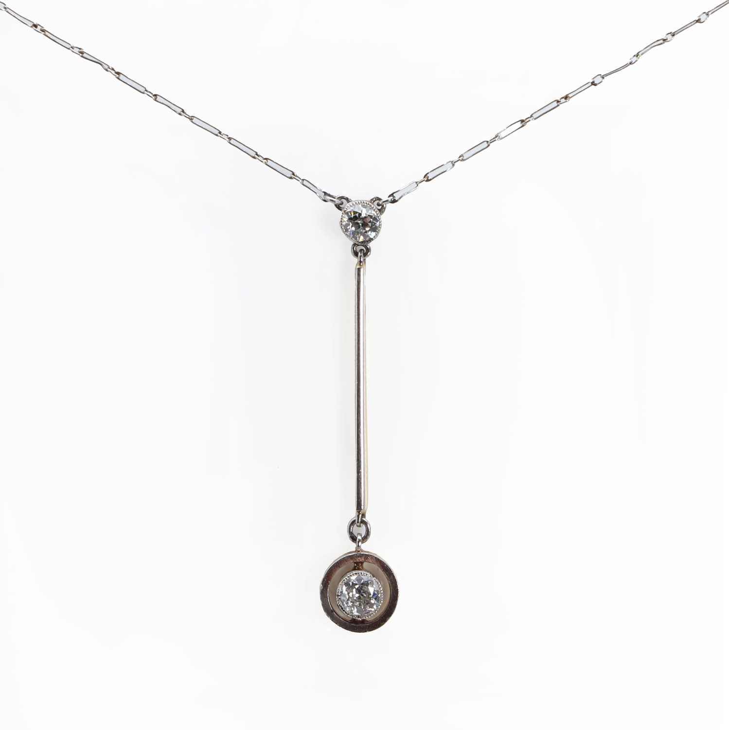 Lot 1026 - A gold Edna May style diamond drop necklace
