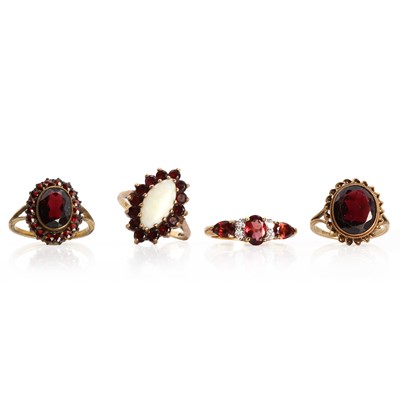 Lot 1289 - A group of four garnet rings