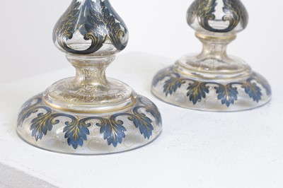 Lot 323 - A pair of enamel and parcel-gilt glass candlesticks