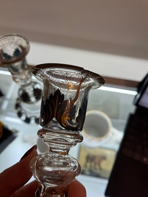 Lot 323 - A pair of enamel and parcel-gilt glass candlesticks