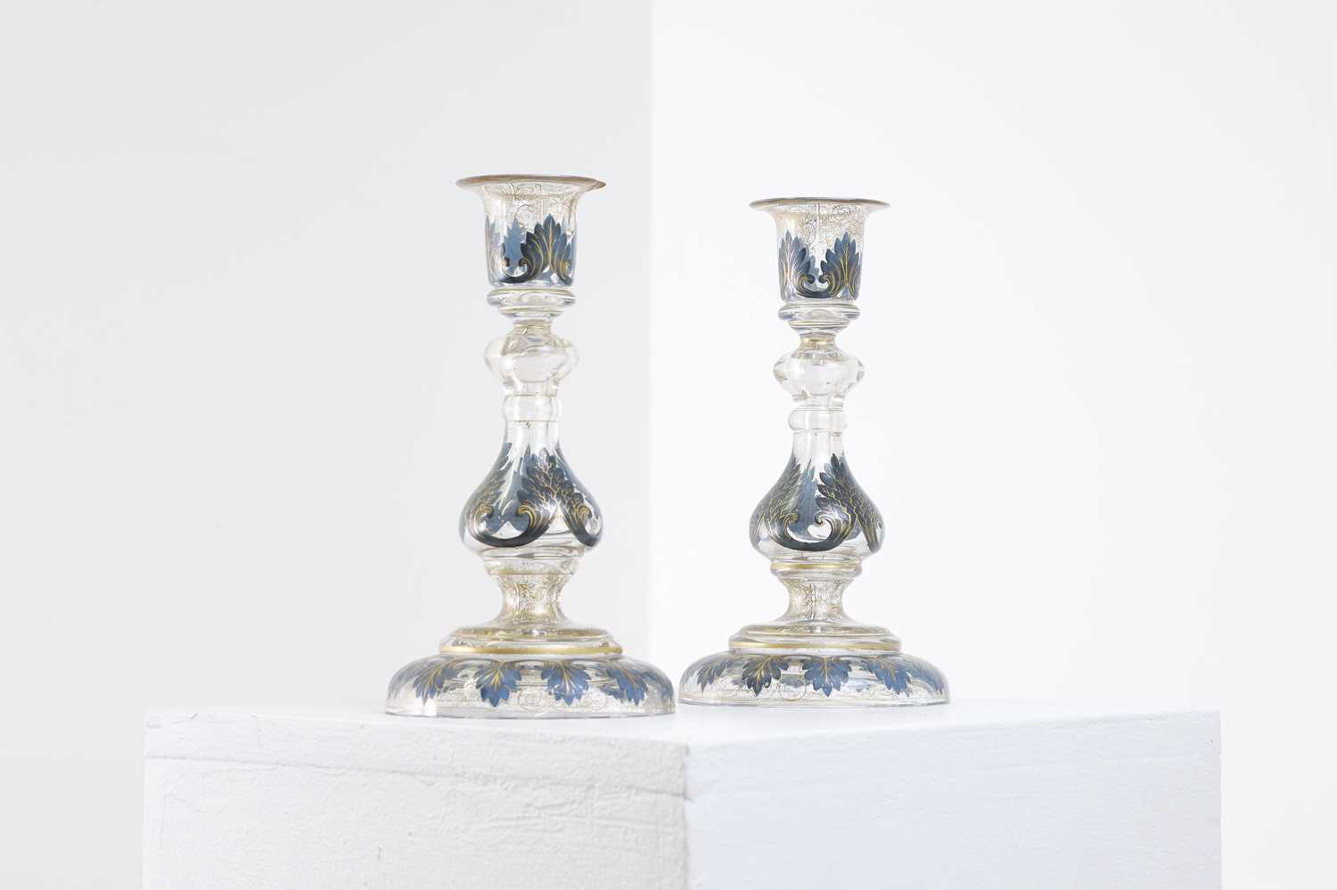 Lot 323 - A pair of enamel and parcel-gilt glass candlesticks