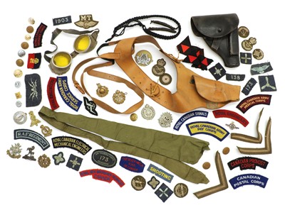 Lot 174 - A group of military badges and shoulder titles