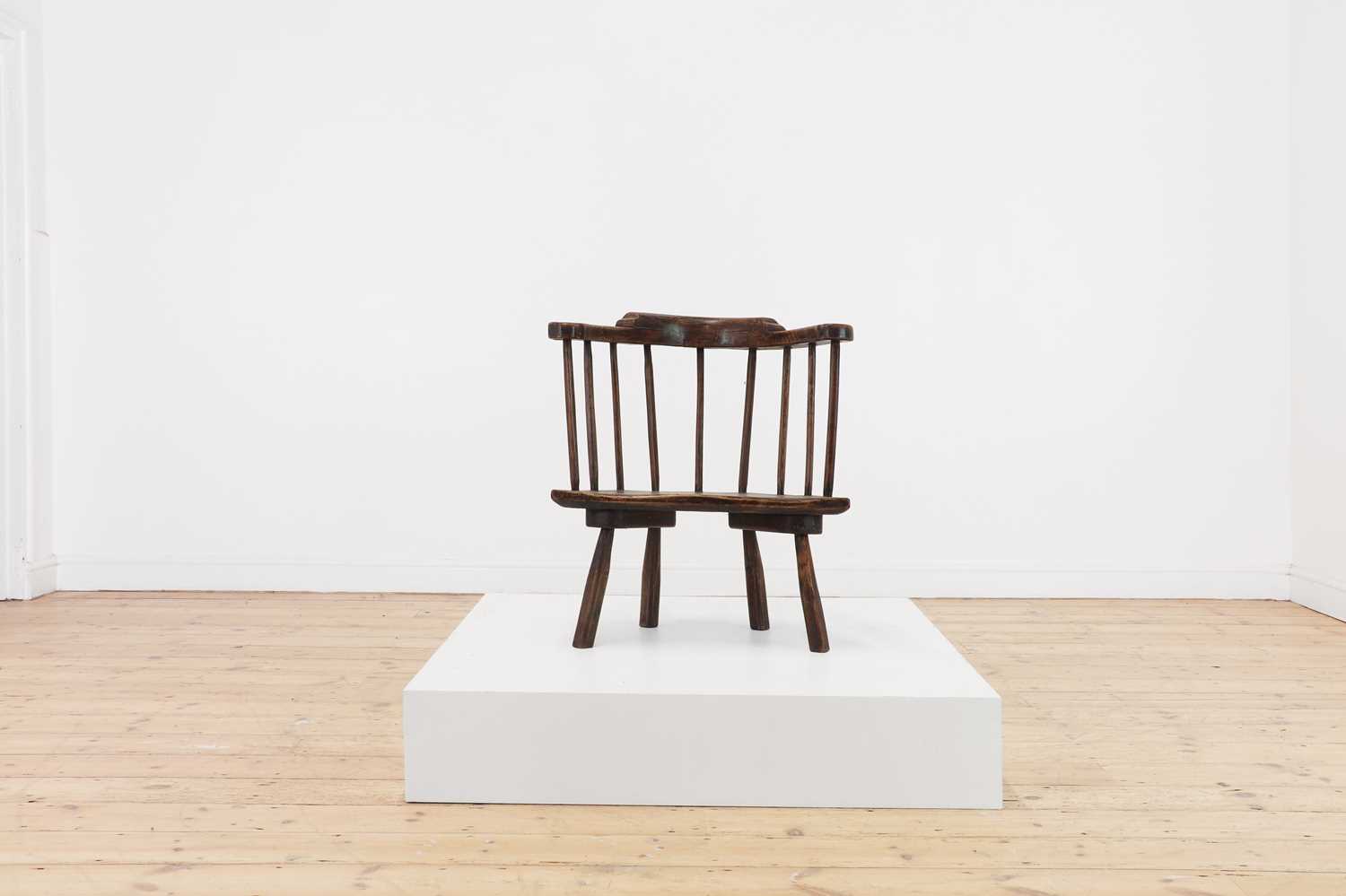 Lot 134 - An elm yoke-back stick chair