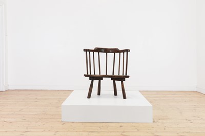 Lot 134 - An elm yoke-back stick chair