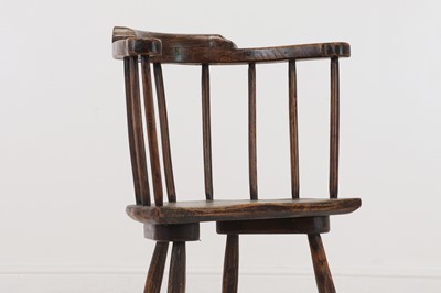 Lot 134 - An elm yoke-back stick chair