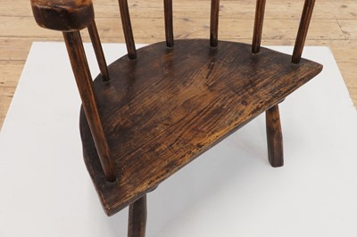 Lot 134 - An elm yoke-back stick chair