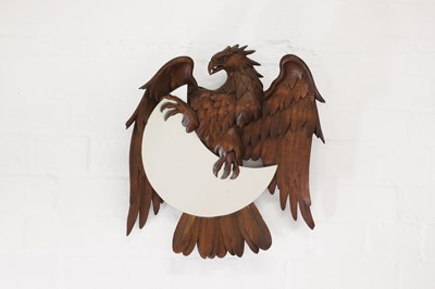 Lot 627 - A Black Forest-style carved beech mirror