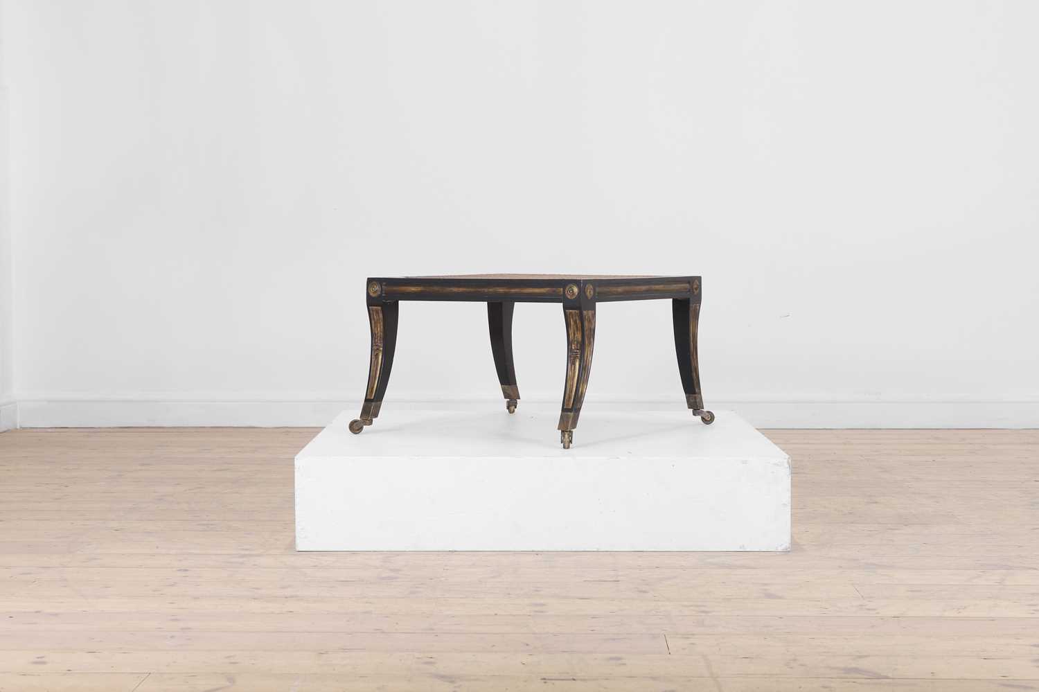 Lot 133 - An Empire-style ebonised and parcel-gilt wooden stool