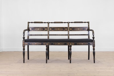 Lot 10 - A Regency-style ebonised and parcel-gilt chair-back settee