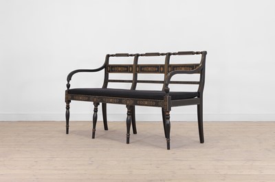 Lot 10 - A Regency-style ebonised and parcel-gilt chair-back settee