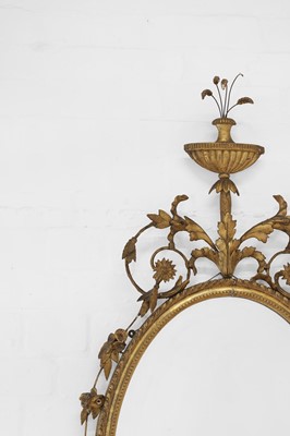 Lot 444 - A George III giltwood and gesso oval mirror