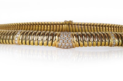 Lot 205 - A two-colour diamond Cartier Tubogas collar necklace