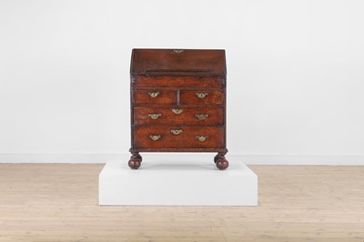 Lot 418 - A small George I oak bureau