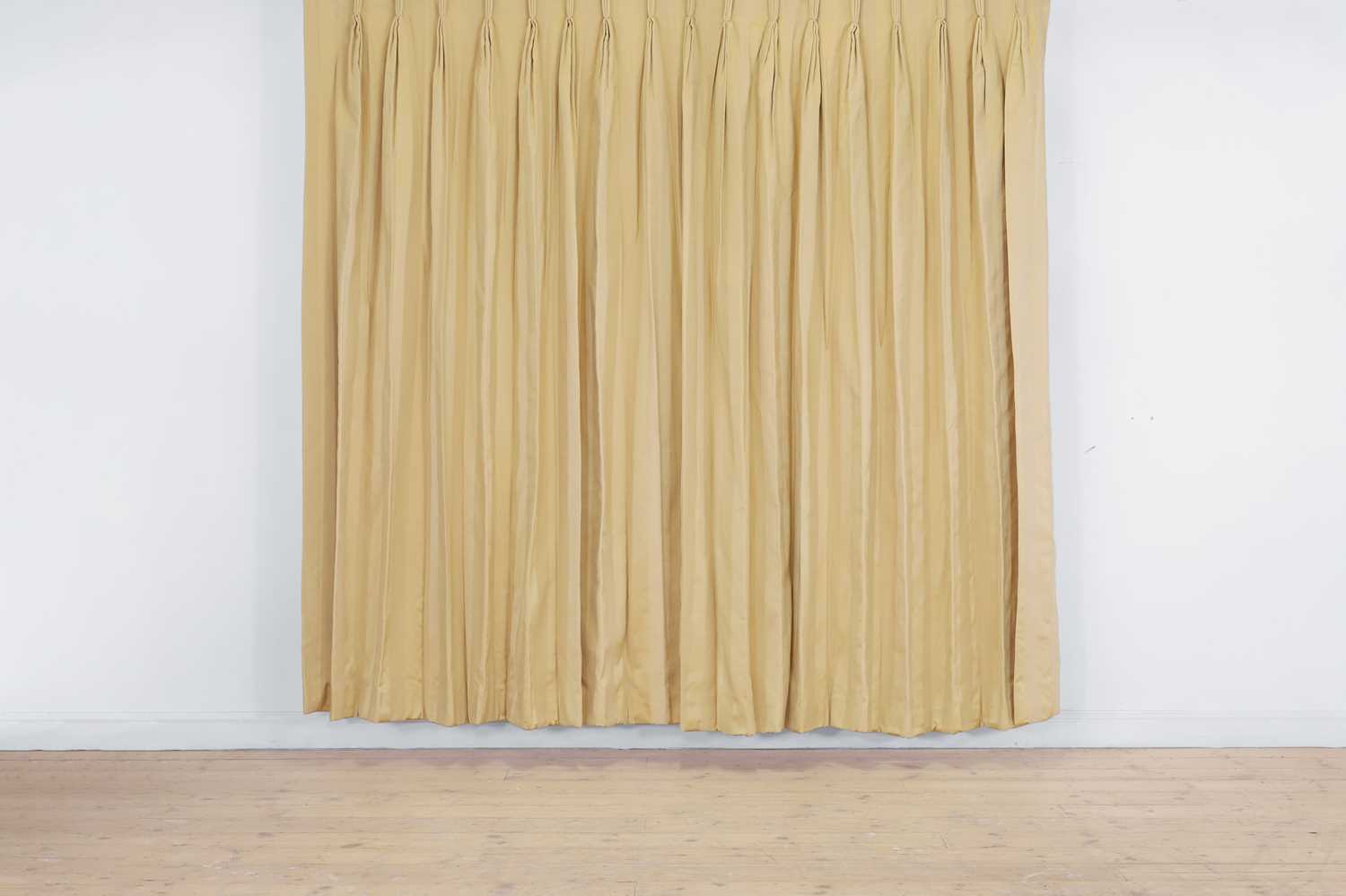 Lot 225 - A pair of pale gold striped silk curtains