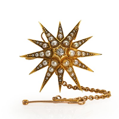 Lot 26 - An Edwardian gold split pearl and diamond starburst brooch