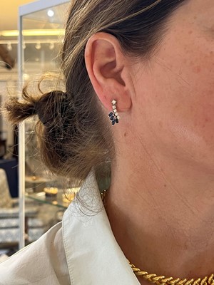 Lot 136 - A pair of 18ct white gold diamond and sapphire drop earrings