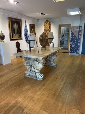 Lot 53 - A marble and travertine console table after the antique
