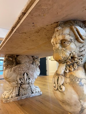 Lot 53 - A marble and travertine console table after the antique