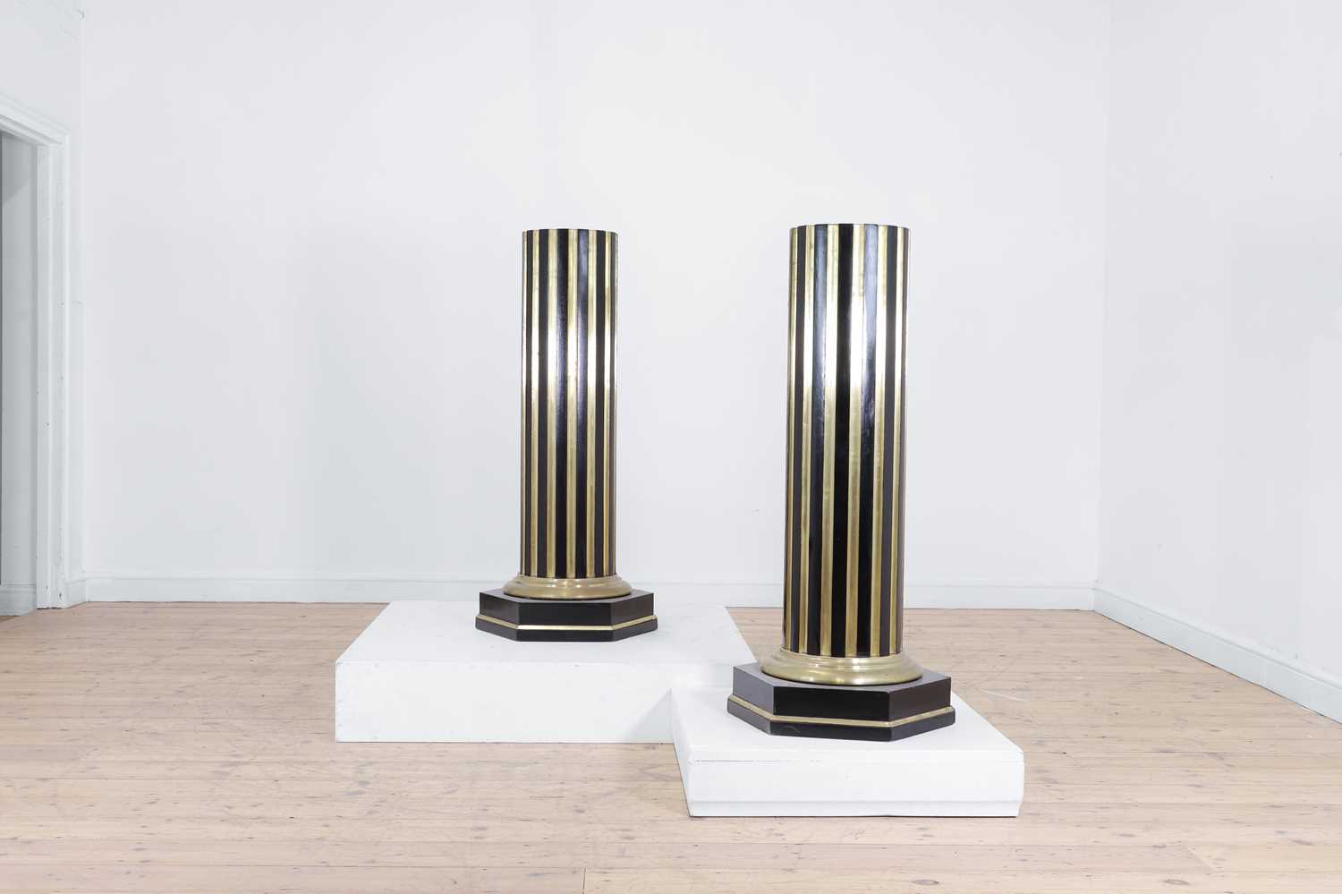 Lot 161 - A pair of ebonised and parcel-gilt wooden columns