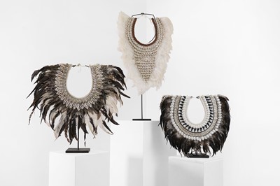 Lot 480 - A group of three cowrie shell and feather necklaces
