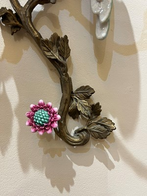 Lot 105 - A pair of porcelain and ormolu wall lights