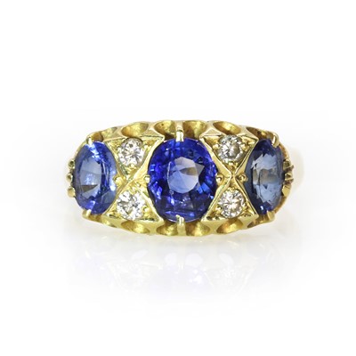 Lot 116 - A gold three stone sapphire and diamond ring