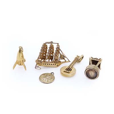 Lot 256 - A group of five gold charms