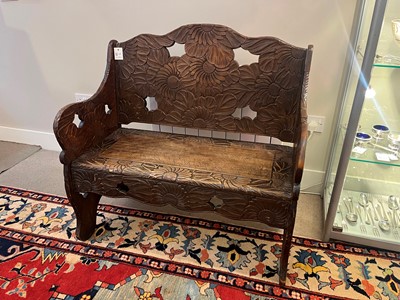 Lot 218 - A carved beech bench for Liberty of London