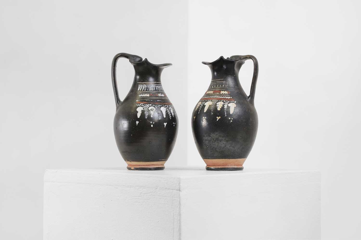 Lot 89 - A near pair of Apulian Gnathian ware pottery oinochoai