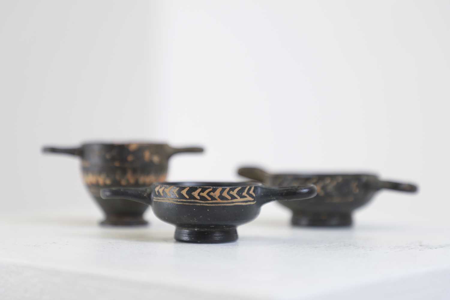 Lot 103 - A group of three Gnathian ware miniature pottery vessels