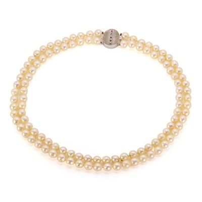 Lot 159 - A two-row uniform pearl necklace with ruby and diamond set textured clasp