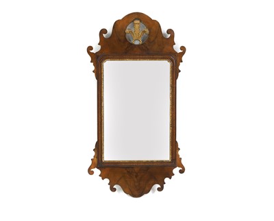 Lot 386 - A George III style walnut and parcel gilt fret carved mirror