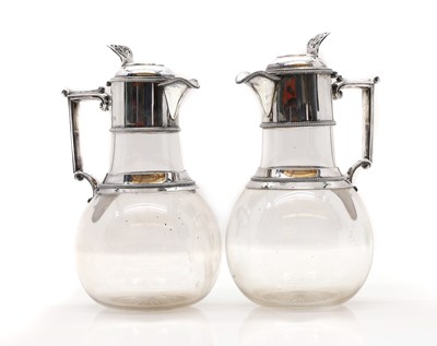 Lot 37 - A pair of Victorian silver mounted glass claret jugs