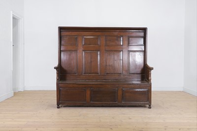 Lot 616 - A panelled oak settle