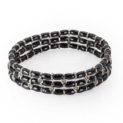 Lot 149 - A white gold diamond and black ceramic bead bracelet, by Jarretiere