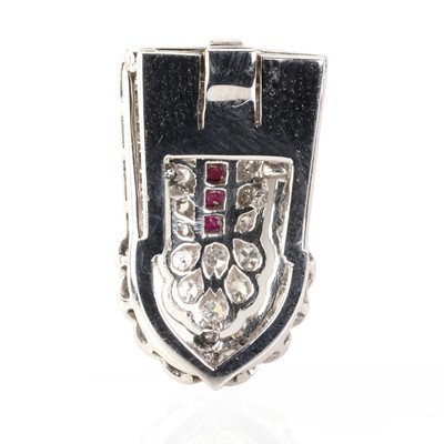 Lot 75 - A diamond and ruby clip brooch, c.1940