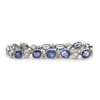 Lot 56 - A Ceylon sapphire and diamond rivière bracelet, c.1920